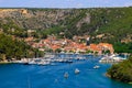 Summer landscape of the Croatian small town Skradin on Krka River. Beautiful yachts and orange buildings in the deep canyon of Royalty Free Stock Photo