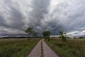 Dirt road and the dark cloudy sky