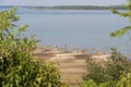 Summer landscape, distant view of people enjoying a river beach in Argentina