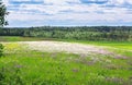 Summer landscape with a field, blue sky and white clouds Royalty Free Stock Photo