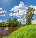 Summer landscape with forest, river, blue sky and white clouds,