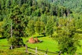 Summer landscape with haystacks in the mountains Royalty Free Stock Photo