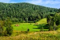 Summer landscape with haystacks in the mountains Royalty Free Stock Photo