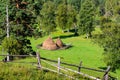 Summer landscape with haystacks in the mountains Royalty Free Stock Photo