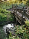 Beautiful  river  and old wooden bridge in the wood Royalty Free Stock Photo