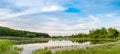 Summer landscape. Lake, forest and blue sky with beautiful clouds. Royalty Free Stock Photo