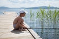 A little boy is fishing on the big lake. Royalty Free Stock Photo