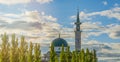 Summer landscape with mosque, minaret and pyramidal poplars in rays of sunset against blue cloudy summer sky. Royalty Free Stock Photo