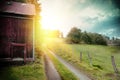 Summer landscape with old barn and country road