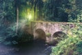 Summer landscape with old cobblestone bridge and small river. Na Royalty Free Stock Photo