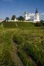 Summer landscape with an old monastery and walking nun Royalty Free Stock Photo