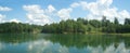 Summer landscape panorama with trees near quiet lake Royalty Free Stock Photo