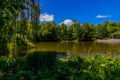 Summer landscape with a pond Saski Garden Warsaw Poland green trees warm day