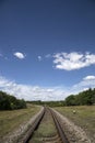 Summer landscape with a railway and a blue sky. Royalty Free Stock Photo