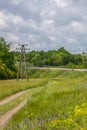Summer landscape with railway, country road and wildflowers Royalty Free Stock Photo