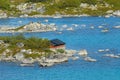 Summer landscape with the red painted cottage at a lake shore in rural Norway. Royalty Free Stock Photo