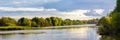 Summer landscape with river, trees and picturesque evening sky