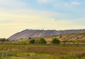 Summer landscape on the salt mountains against the blue sky. Mining industry. Extraction of silica from the ground near the city