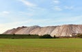 Summer landscape on the salt mountains against the blue sky. Mining industry. Extraction of silica from the ground near the city