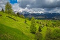 Summer landscape with snowy mountains and Pestera village, Transylvania, Romania Royalty Free Stock Photo