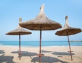 Summer landscape with straw umbrellas on the beach in Mangalia or Mamaia. Beach at the Black Sea in Romania