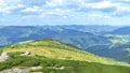 Summer landscape from the top of the mountain, overlooking the green mountain range and pines. 16:9 Royalty Free Stock Photo