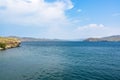 Summer landscape. Turquoise water, blue sky and mountains in the haze. Strait of Olkhon Gate. Lake Baikal, Siberia, Russia Royalty Free Stock Photo