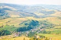 Summer landscape with village in valley and mountain in Carpathians, Ukraine. Tranquil scenery, soft focus Royalty Free Stock Photo