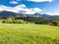 Summer landscape wallpaper with green field and dramatic razor sharp cloudy sky and warm sun rays