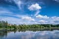 Summer landscape: white clouds in blue sky are reflected in pur Royalty Free Stock Photo