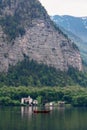 Summer landscaped, Green forests with mountain and a man sailing boat in lake at Hallstatt, Austria in summer Royalty Free Stock Photo