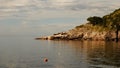 The sun sets on the rocky shores