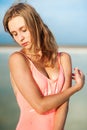 Summer lifestyle fashion portrait of young stunning blonde woman. Sunbathing, enjoying life. Wearing stylish pink swimsuit. Young Royalty Free Stock Photo