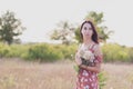 Summer lifestyle portrait of beautiful romantic girl holding bouquet of wild flowers Royalty Free Stock Photo