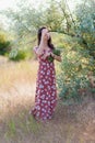 Summer lifestyle portrait of beautiful romantic girl holding bouquet of wild flowers Royalty Free Stock Photo