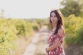 Summer lifestyle portrait of beautiful romantic girl holding bouquet of wild flowers Royalty Free Stock Photo