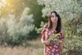 Summer lifestyle portrait of beautiful romantic girl holding bouquet of wild flowers Royalty Free Stock Photo