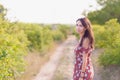 Summer lifestyle portrait of beautiful romantic girl holding bouquet of wild flowers Royalty Free Stock Photo