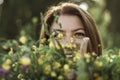 Summer lifestyle portrait of beautiful young woman smiling and holding bouquet of wild flowers. Standing in the field of grass. Royalty Free Stock Photo