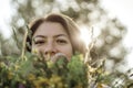 Summer lifestyle portrait of beautiful young woman smiling and holding bouquet of wild flowers. Standing in the field of grass. Royalty Free Stock Photo