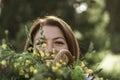 Summer lifestyle portrait of beautiful young woman smiling and holding bouquet of wild flowers. Standing in the field of grass. Royalty Free Stock Photo