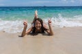 Summer lifestyle portrait of happy pretty young woman with tanned body. Enjoying life and lying in the clear sea Royalty Free Stock Photo