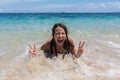 Summer lifestyle portrait of happy pretty young woman with tanned body. Enjoying life and lying in the clear sea Royalty Free Stock Photo