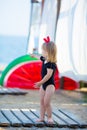 Summer lifestyle portrait of pretty girl swimming posing on the back on the inflatable watermelon in the ocean, wearing stylish Royalty Free Stock Photo