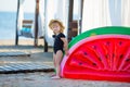 Summer lifestyle portrait of pretty girl swimming posing on the back on the inflatable watermelon in the ocean, wearing stylish Royalty Free Stock Photo