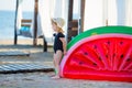 Summer lifestyle portrait of pretty girl swimming posing on the back on the inflatable watermelon in the ocean, wearing stylish Royalty Free Stock Photo