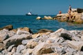 Summer lifestyle and vacation concept. Selective focus on the foreground, blurred island with people and ship in the background