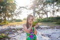 Young beautiful woman holding coconut and standing near palms Royalty Free Stock Photo