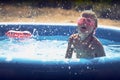 Summer little girl playing in the pool Royalty Free Stock Photo