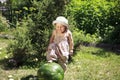 Summer, little girl steps on a watermelon,